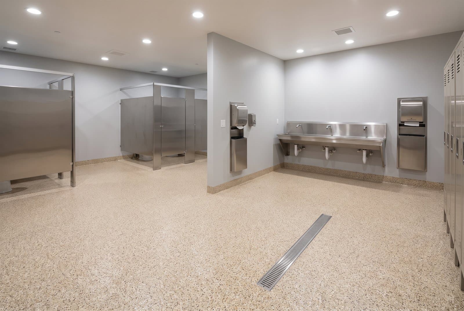 Decorative quartz broadcast epoxy floor with fine tan aggregate texture