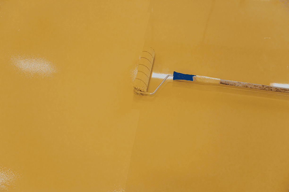 Finished basement living space with warm metallic epoxy floor — RamRock Coatings, Cedar Rapids IA